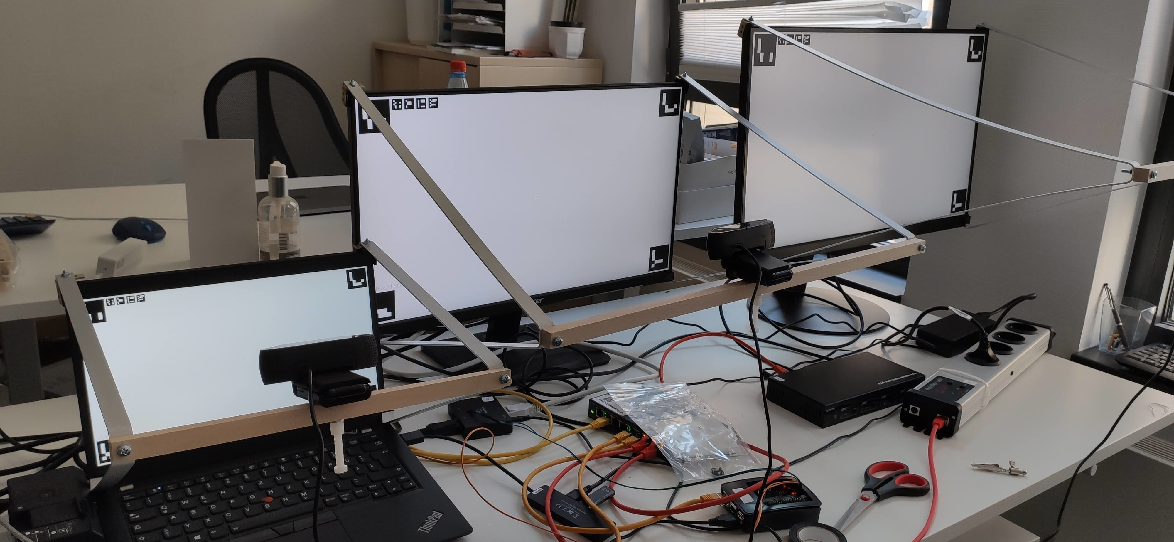 Physical Prototype System and Display Test Setup: The odd part of this project are these hand-crafted display frames that hold the webcams in the right place.